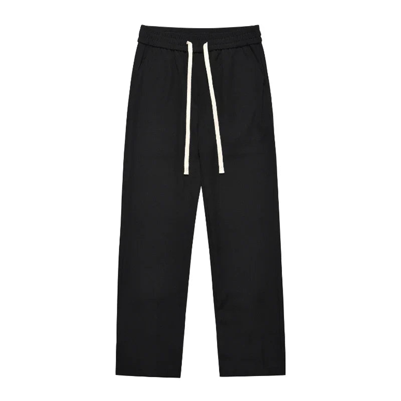 Sophisticated retro-style casual suit trousers in black and apricot colours, featuring a sleek straight-leg silhouette and distinctive back slit