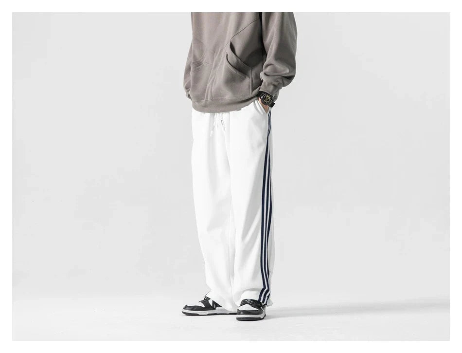 Stylish striped sports trousers in a relaxed, mid-waist design for versatile leisure and athletic wear