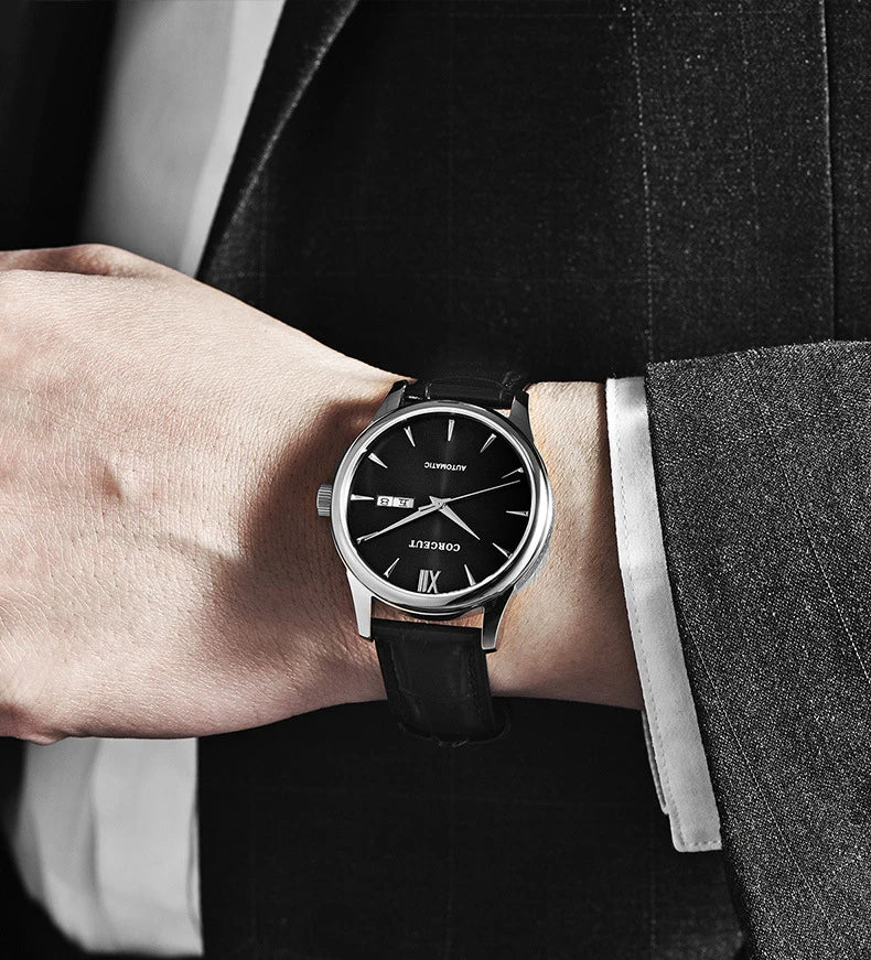 A sophisticated automatic mechanical watch with a gold/white or gold/black face, stainless steel case, and genuine leather strap