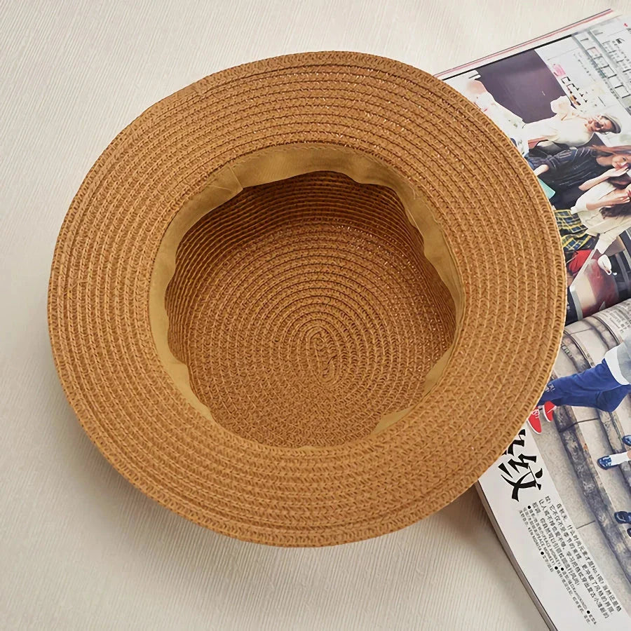 A classic summer Panama hat made from straw and paper, featuring a charming bow detail that adds a feminine touch.
