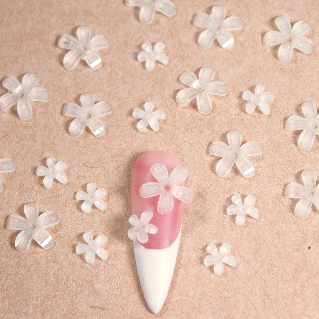 Elegant 3D flower nail charms in white and pink colours, featuring a transparent jelly finish and rhinestone accents for a stylish manicure