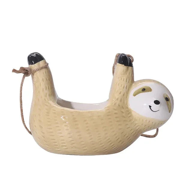 Ceramic hanging planter with a whimsical cartoon animal design, available in grey or yellow, for adding a touch of nature and playfulness to indoor spaces.