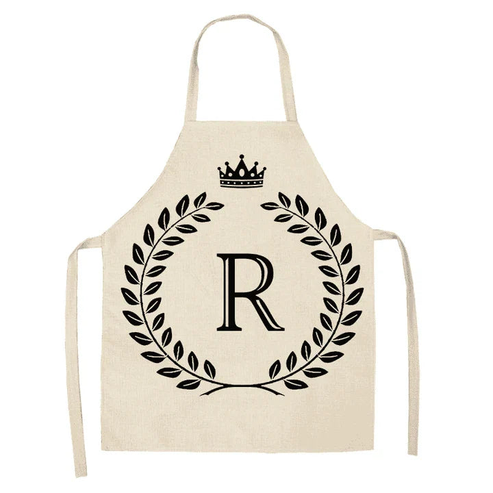 A high-quality kitchen apron featuring a charming crown and letter print design in a premium cotton and linen blend fabric.