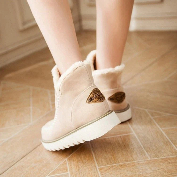 A pair of stylish, non-slip snow boots with a warm artificial wool lining, perfect for British winter weather