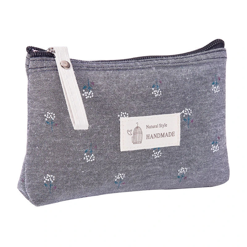 A stylish floral canvas cosmetic bag with a secure zipper closure, perfect for organising and carrying your makeup and toiletries while traveling.