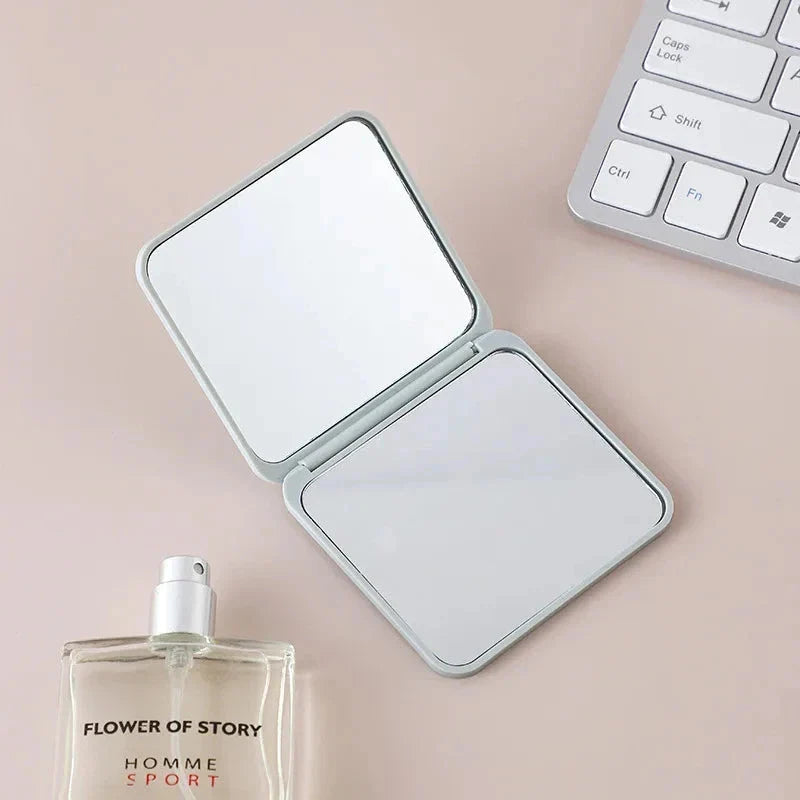 Portable Folding Double-Sided Makeup Mirror in Blue, Pink, Black, and Silver Colours