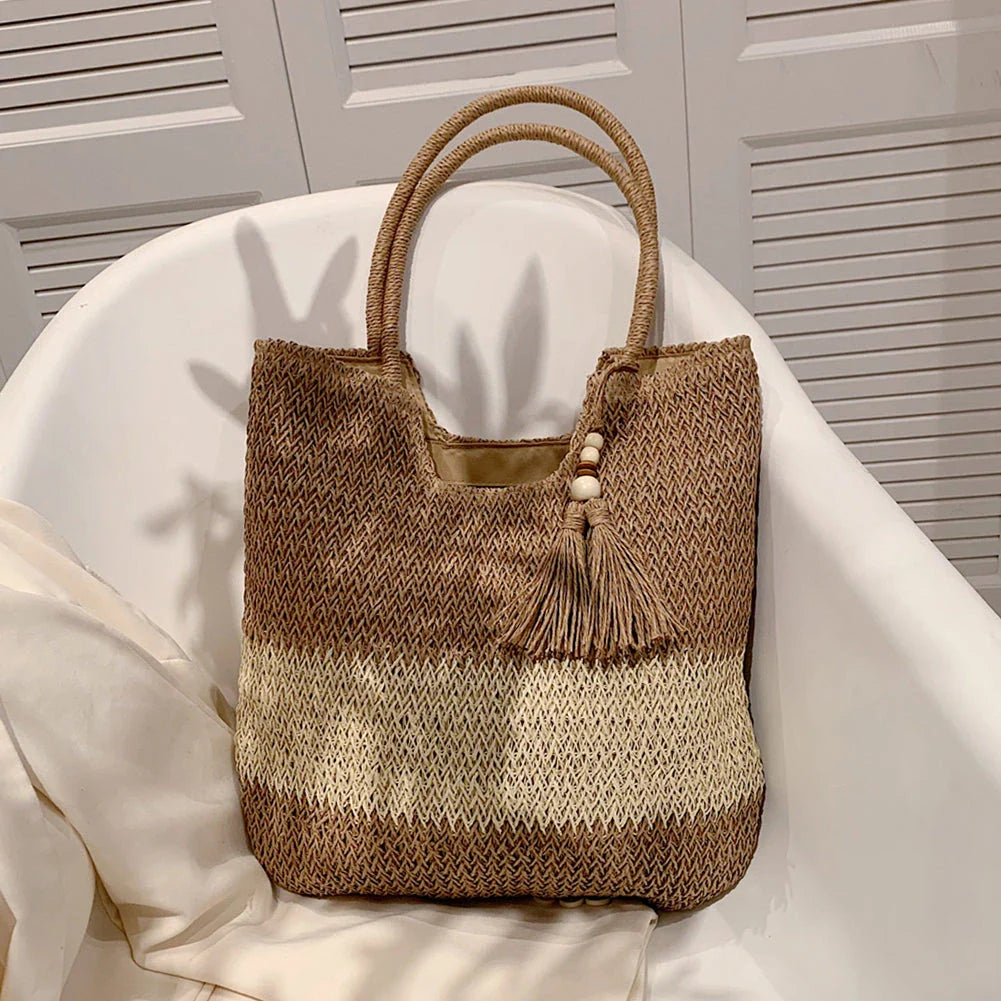 Stylish bohemian-inspired woven tote bag with contrasting tassels, perfect for summer outings