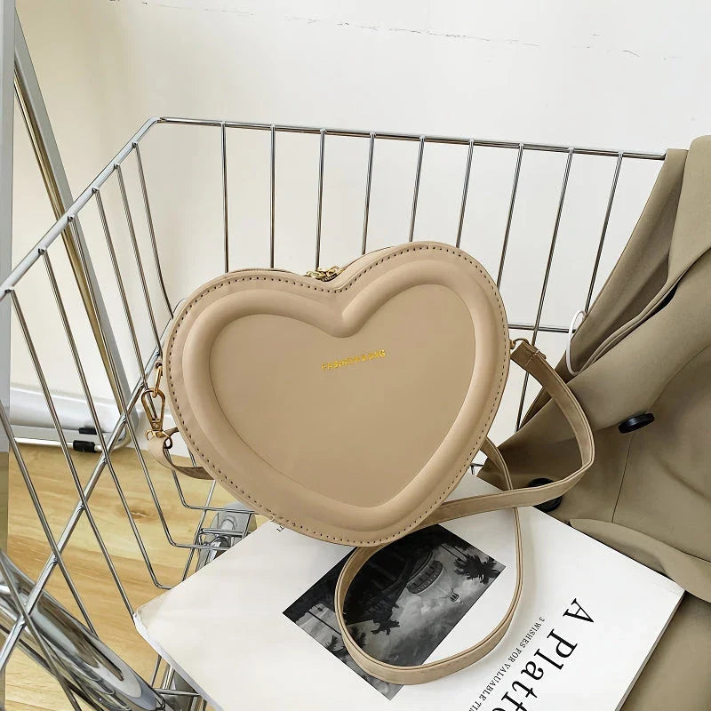 Chic heart-shaped crossbody bag made from premium PU leather, available in multiple stylish colours