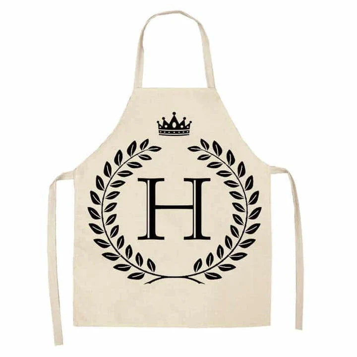 A high-quality kitchen apron featuring a charming crown and letter print design in a premium cotton and linen blend fabric.