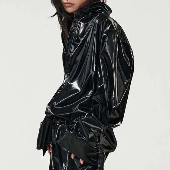 Elegant, fleece-lined PU leather jacket in a sleek, glossy black finish for timeless style and comfort