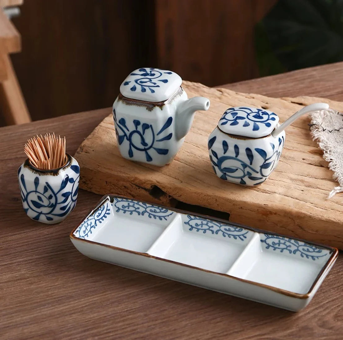 Premium four-piece ceramic seasoning set with oil, vinegar, seasoning, and toothpick holder for a stylish and organized kitchen