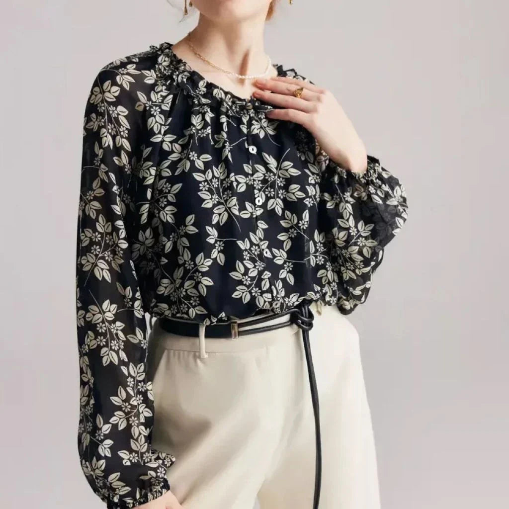 Floral silk blouse with ruffles and round neckline, showcasing the elegant and comfortable design for versatile wear.