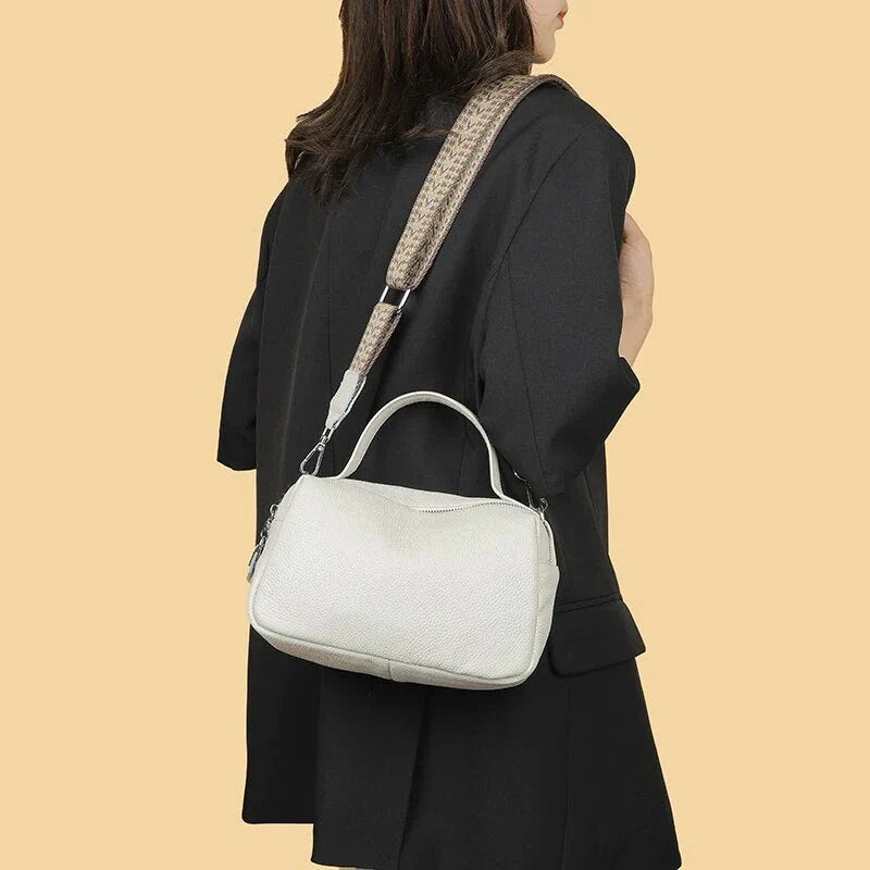 Luxurious genuine leather crossbody bag for women, featuring a soft polyester lining, dual phone pockets, and a compact, square design.