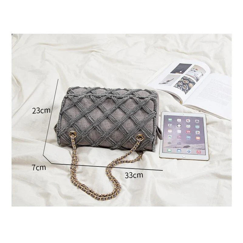 A stylish, retro-inspired shoulder bag with a minimalist rhombus pattern design, perfect for the modern, fashion-conscious woman in the UK.