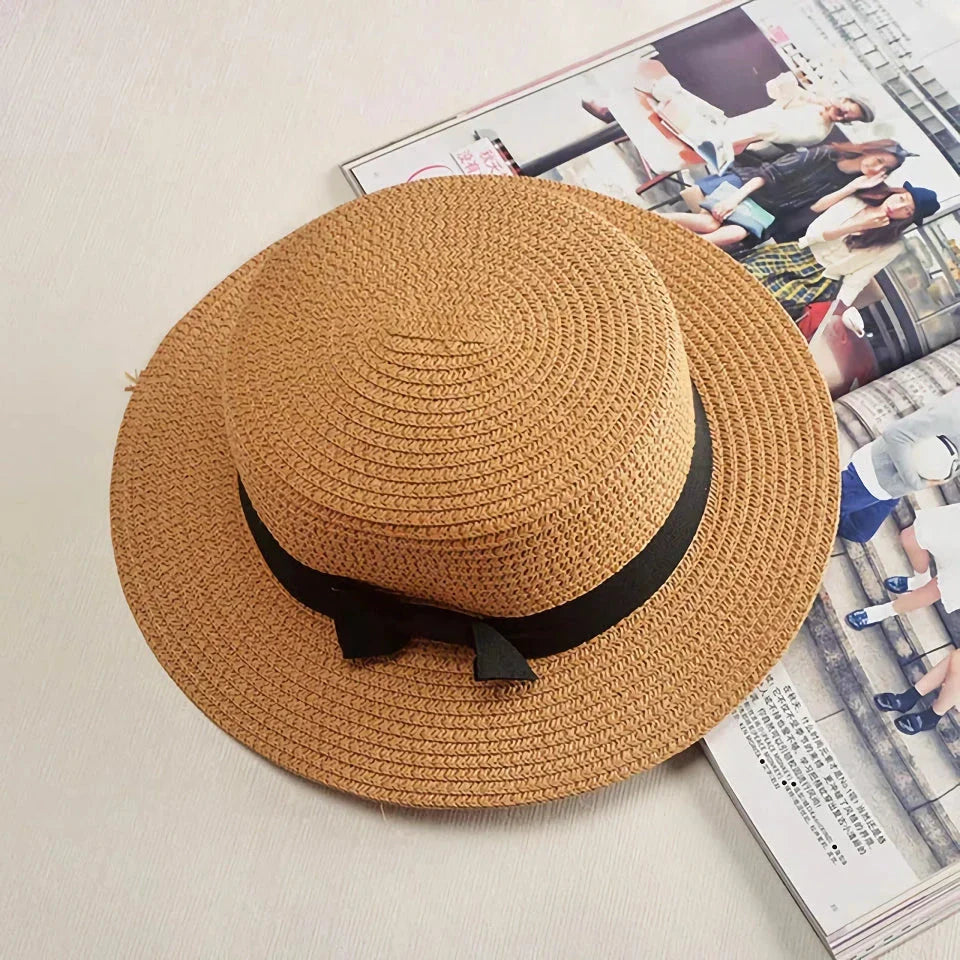 A classic summer Panama hat made from straw and paper, featuring a charming bow detail that adds a feminine touch.