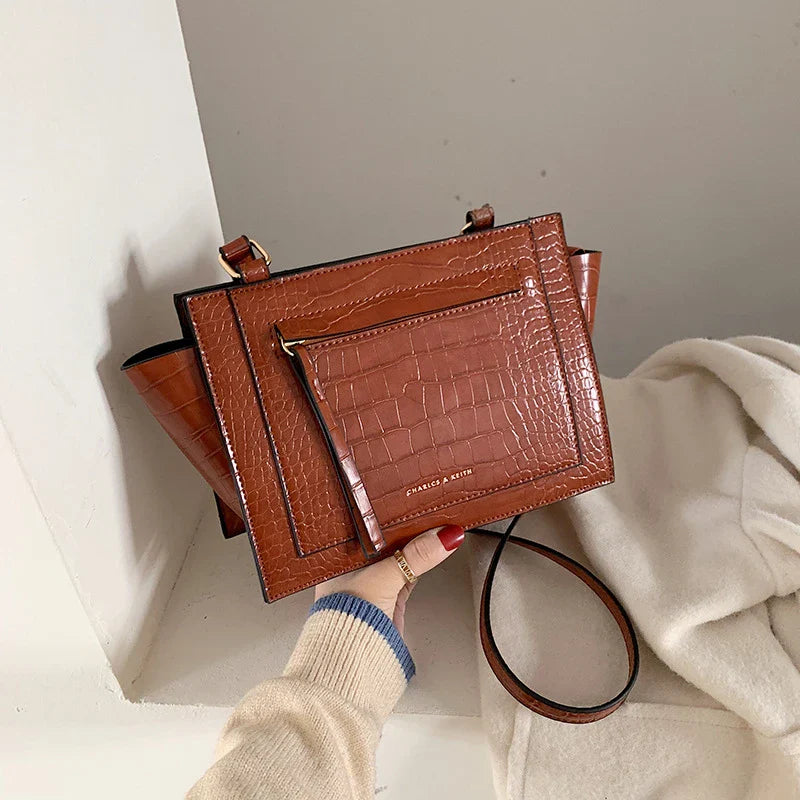 Premium British-designed messenger bag in wine red colour, featuring a spacious and stylish design with a single strap for comfortable carrying.