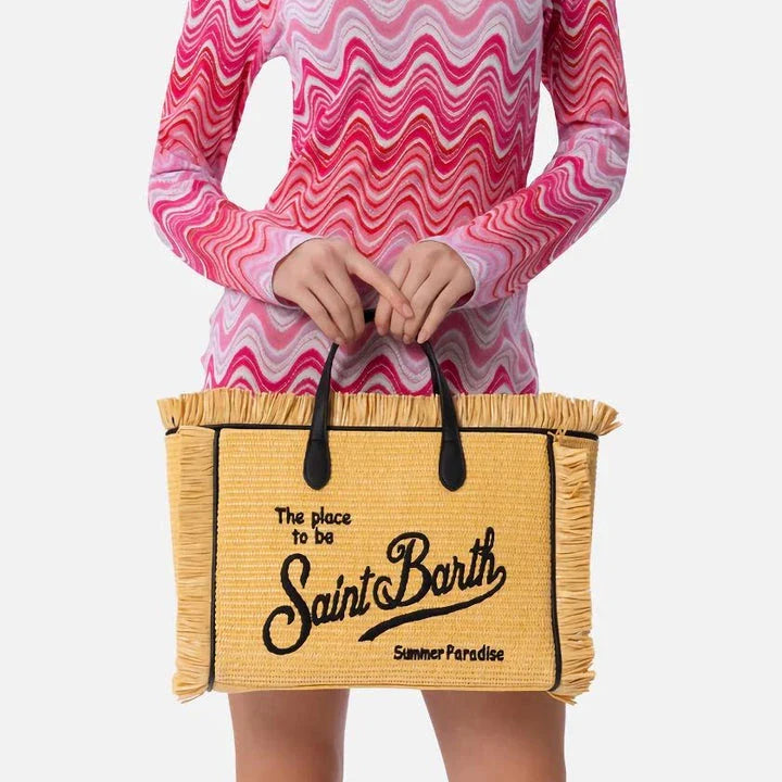 Stylish embroidered straw tote bag with playful tassels, perfect for summer outings and beach adventures.