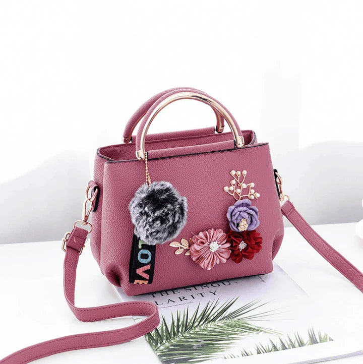 Elegant leather tote bag with delicate flower embellishments, perfect for modern British fashion