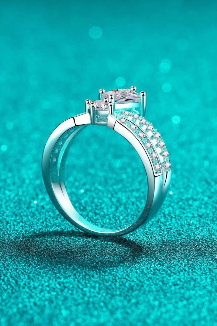 Elegant sterling silver ring with a moissanite centre stone and zircon accents, featuring a modern and minimalist crown design