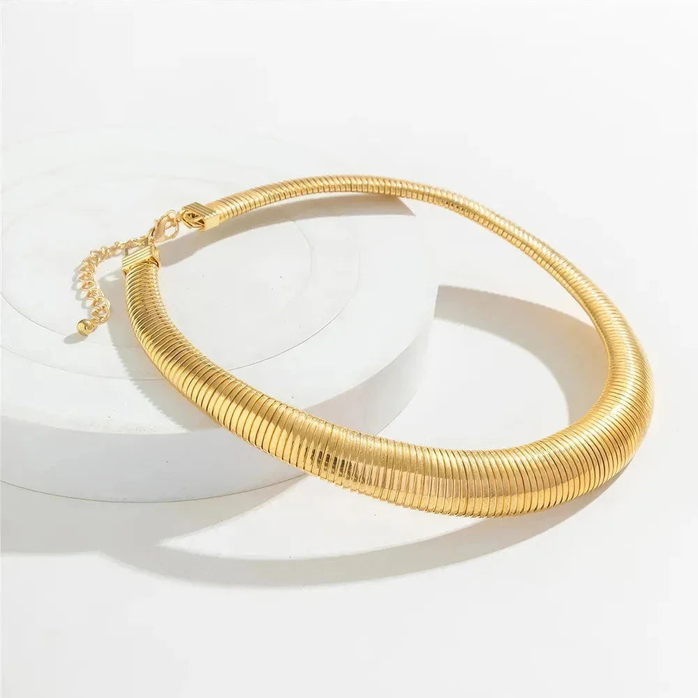 Captivating spiral chunky choker necklace in gold and silver colours, featuring a bold, geometric design for a unique, statement-making look.