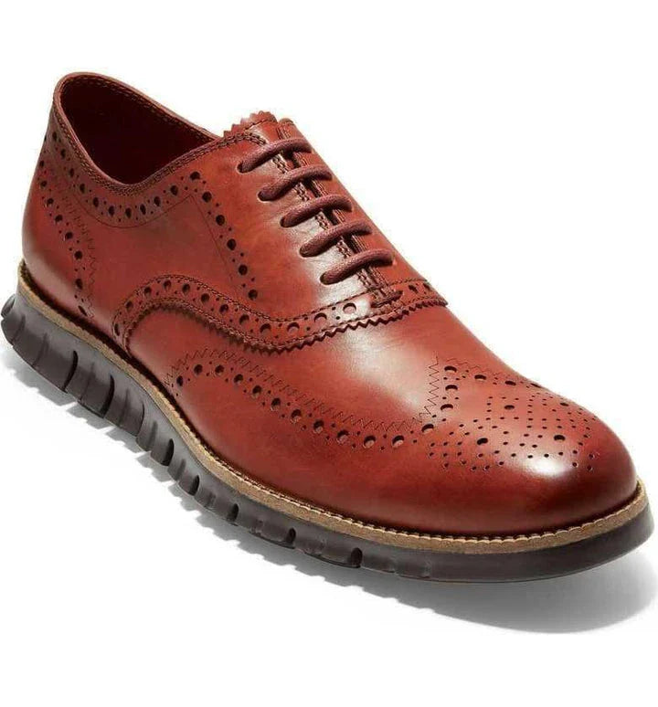 A pair of premium leather business shoes with a thick rubber sole and a stylish leather toe cap, available in brown and black colours.