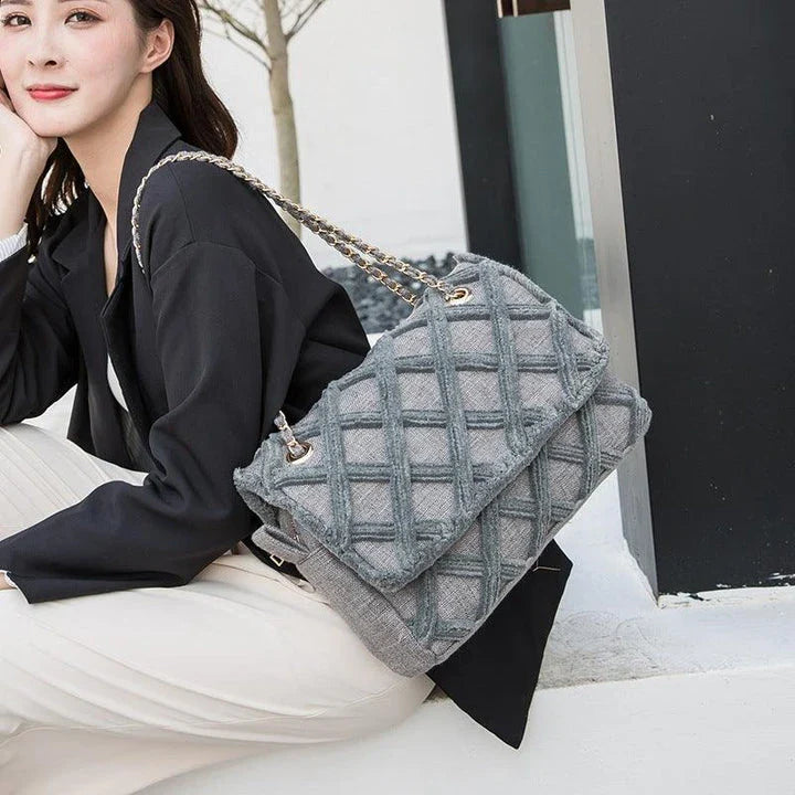 A stylish, retro-inspired shoulder bag with a minimalist rhombus pattern design, perfect for the modern, fashion-conscious woman in the UK.
