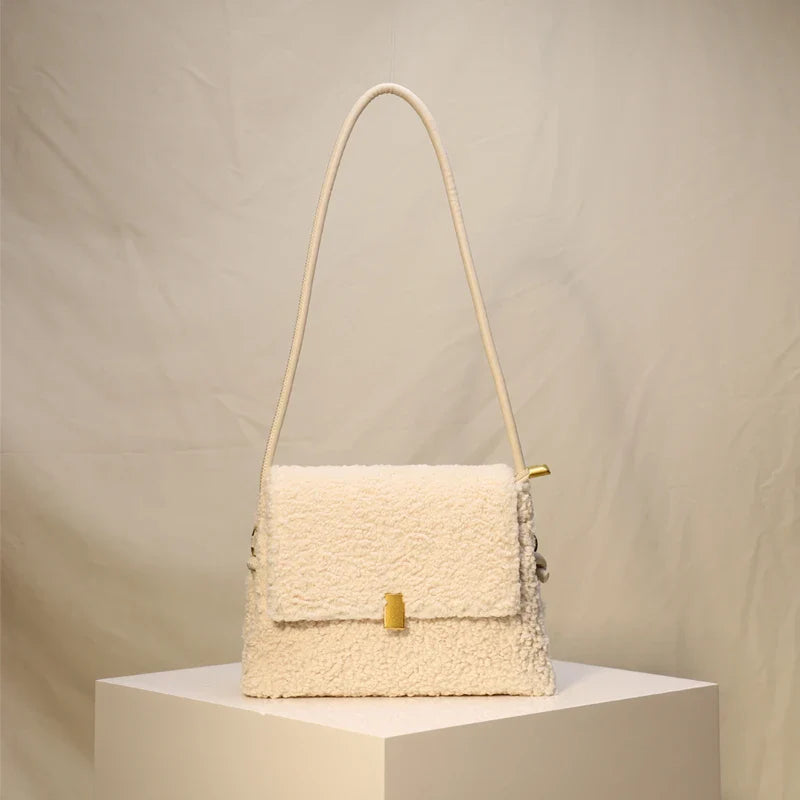 A stylish faux lamb wool crossbody bag in beige, black, or khaki brown with a contemporary design and practical storage features