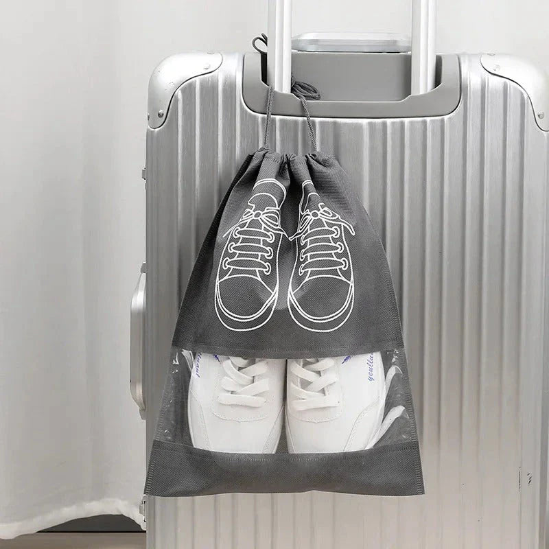 A set of grey travel shoe storage organiser bags with transparent panels for easy identification of contents