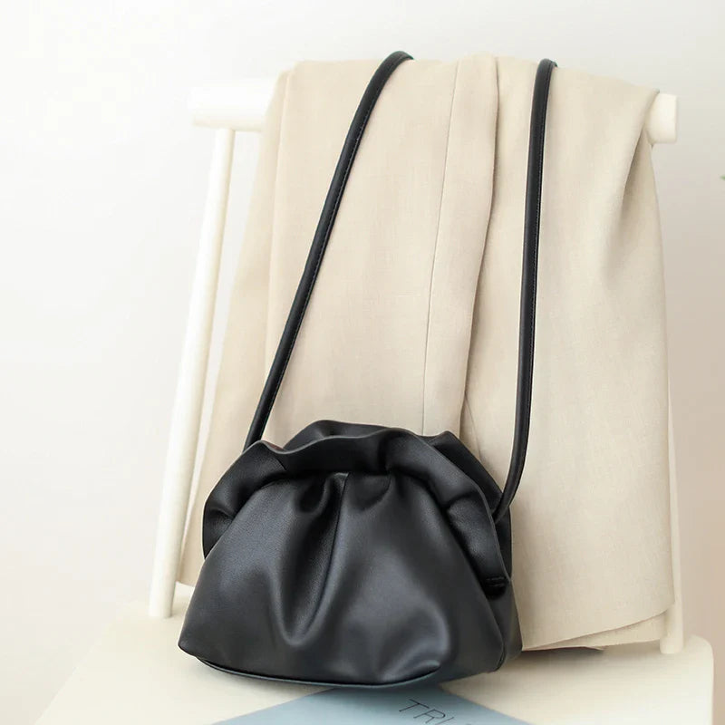 Stylish retro dumpling bag in premium PU material with one-shoulder design and adjustable strap, available in classic British colours