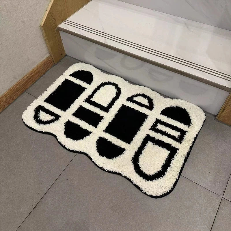 Tufted black and white geometric area rug with a soft, plush texture and anti-slip backing