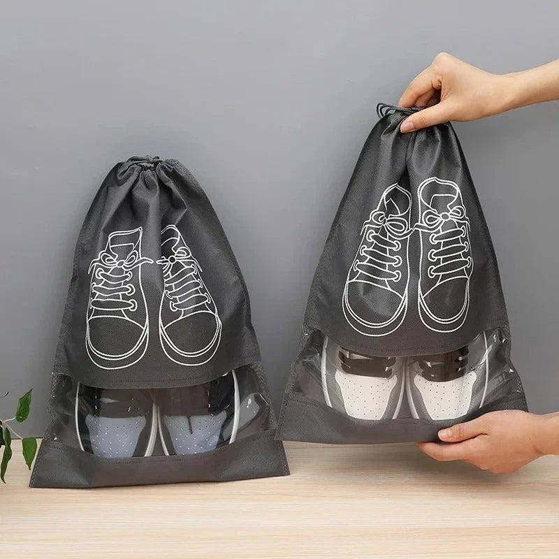 A set of grey travel shoe storage organiser bags with transparent panels for easy identification of contents