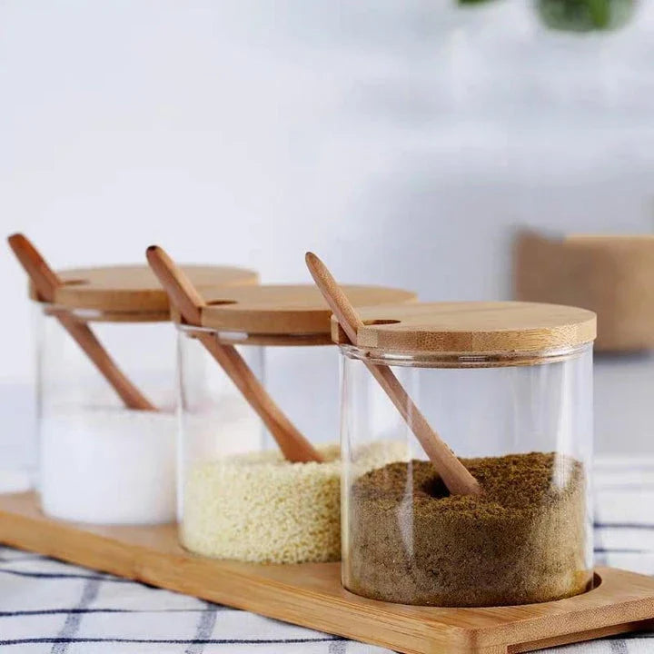 Elegant glass canister with wooden spoon, a versatile kitchen accessory for storing and displaying pantry items