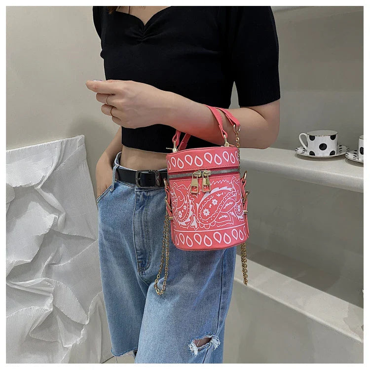 Premium PU leather bucket bag in a variety of classic and contemporary colours, featuring a spacious main compartment, adjustable shoulder strap, and sophisticated British-inspired design.