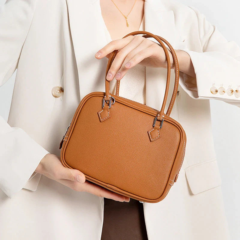 Elegant leather mini shoulder bag in a variety of colours, featuring a compact and versatile design for the stylish British woman.