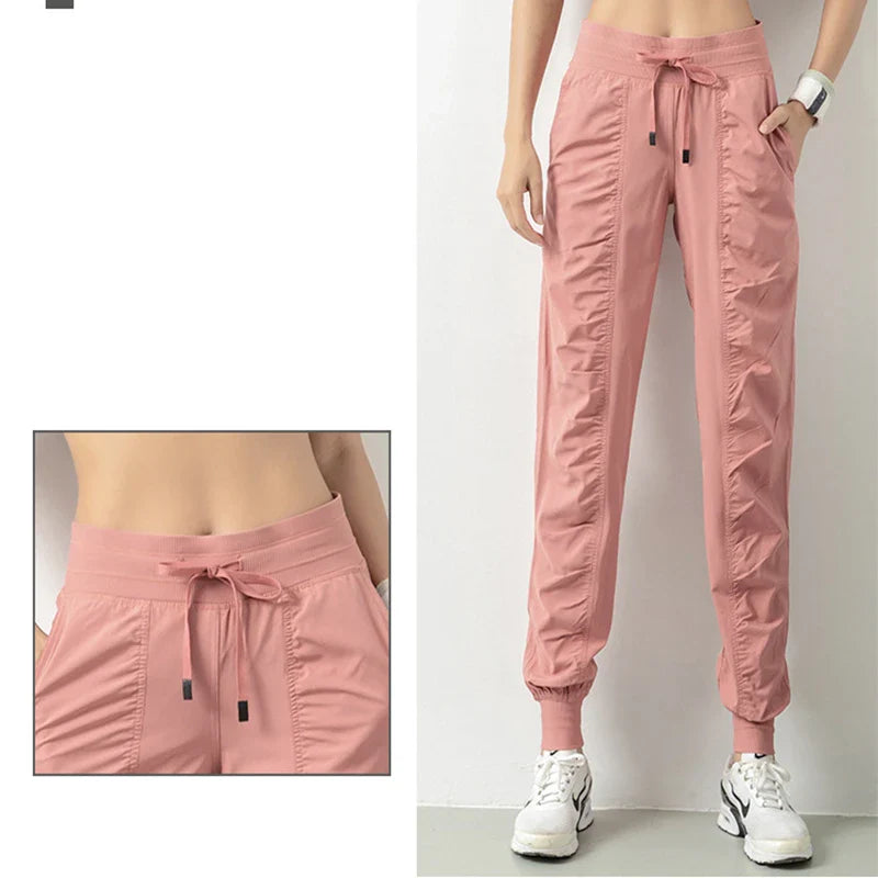 Premium women's sports trousers with drawstring waist and pockets, made of high-quality nylon fabric for comfort and versatility.