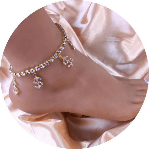 Sparkling gold-colored brass anklet adorned with dollar charms and rhinestones