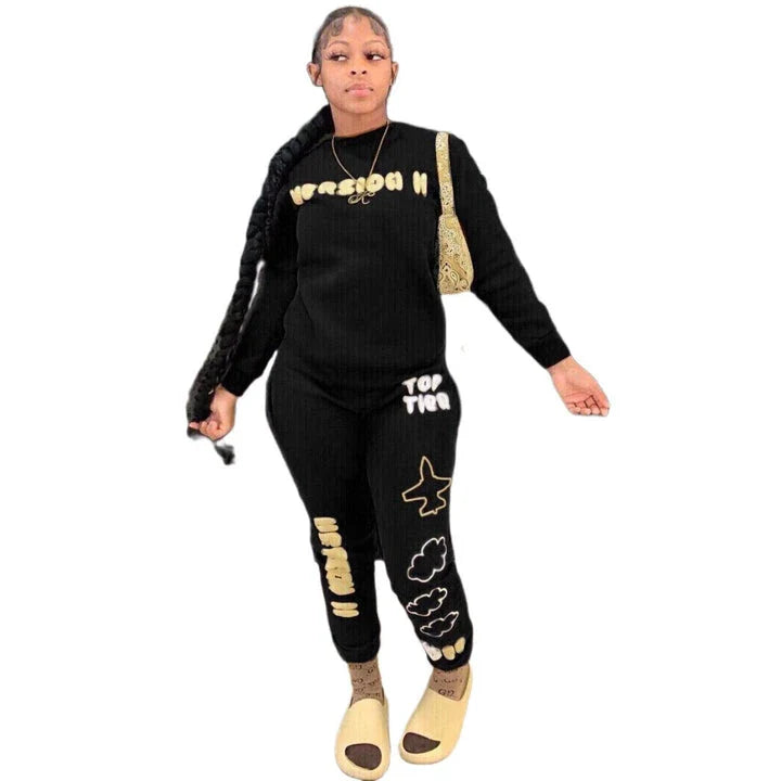 Stylish two-piece casual sports outfit for women, featuring a relaxed top and comfortable trousers in black and brown colors.