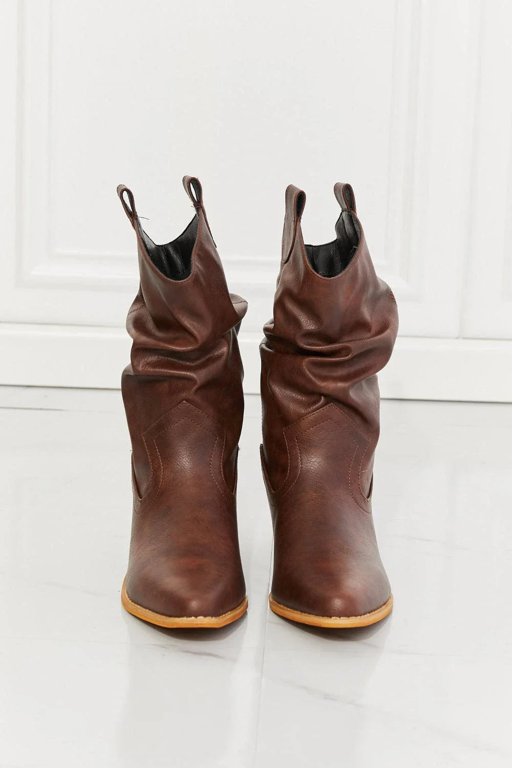 Stylish scrunch cowboy boots in a rich brown colour, perfect for pairing with jeans or dresses for a touch of rustic charm.