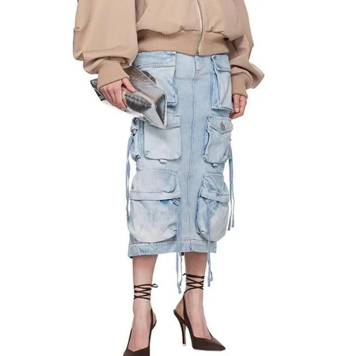 A high-waisted denim skirt with distressed detail and a ribbon slit, perfect for spring fashion