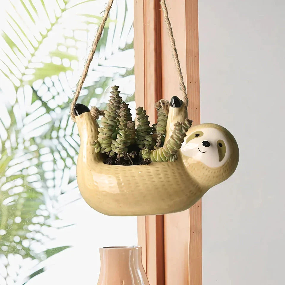 Ceramic hanging planter with a whimsical cartoon animal design, available in grey or yellow, for adding a touch of nature and playfulness to indoor spaces.