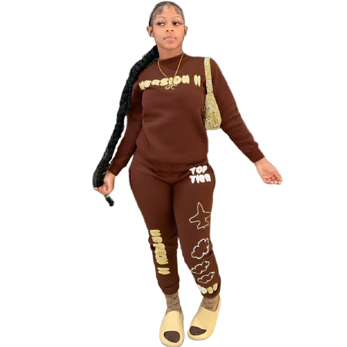 Stylish two-piece casual sports outfit for women, featuring a relaxed top and comfortable trousers in black and brown colors.