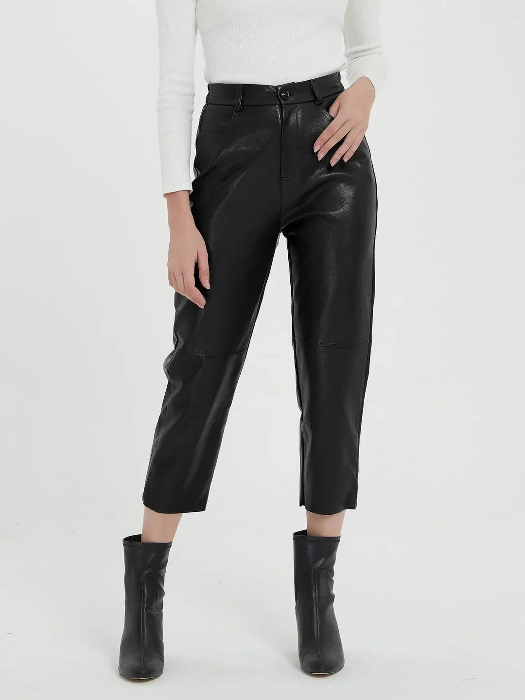 Pair of high-waisted, ankle-length faux leather trousers in a classic brown colour