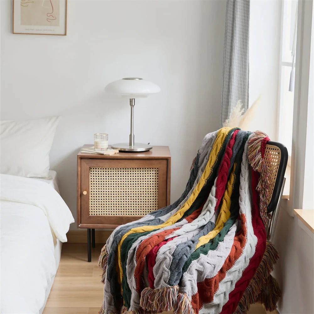 Elegant wool blanket with stylish plaid pattern and fringed tassels, perfect for cosy home decor and outdoor adventures.