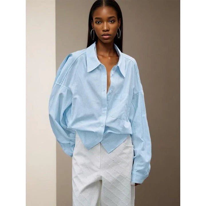 A stylish patchwork blouse with functional pockets, perfect for casual and semi-formal occasions during the autumn and winter seasons.