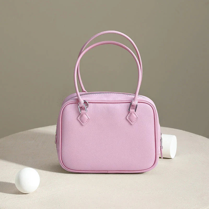 Elegant leather mini shoulder bag in a variety of colours, featuring a compact and versatile design for the stylish British woman.
