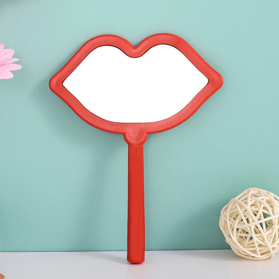 Lip-shaped handheld makeup mirror with a comfortable ergonomic handle for precise on-the-go touch-ups