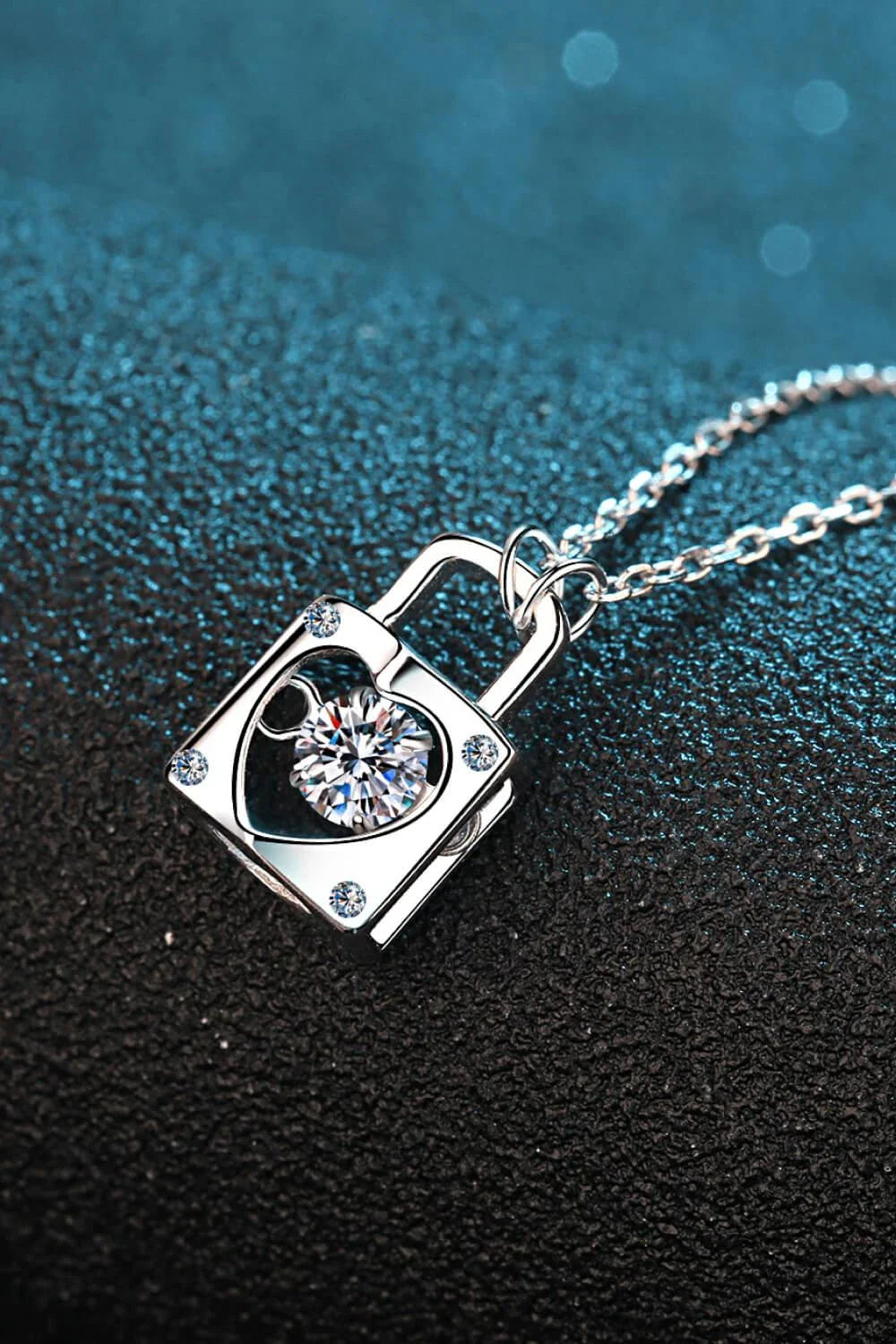 Elegant sterling silver moissanite lock pendant necklace with a minimalist, modern design