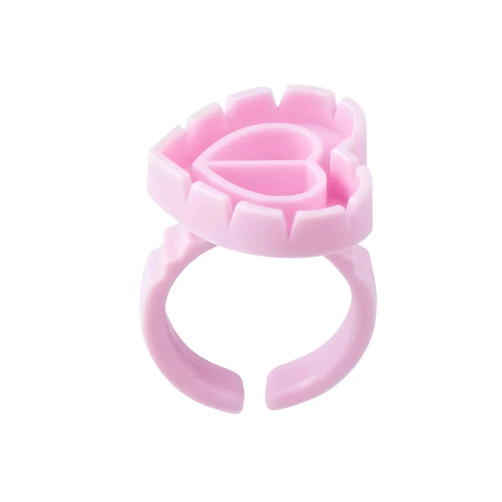 Heart-shaped disposable eyelash glue rings in blue, pink, and white colours