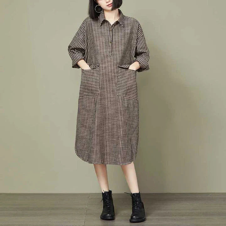 Plus-size women's dress with a striped pattern, asymmetric skirt, and long loose sleeves