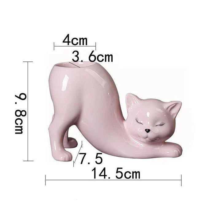 A white ceramic flower pot with a playful cartoon cat design and a functional tail element, perfect for desktops and small spaces.